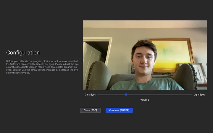 A window with the title Configuration, some text, a live webcam view, a slider for eye color threshold, a close button, and a continue button.